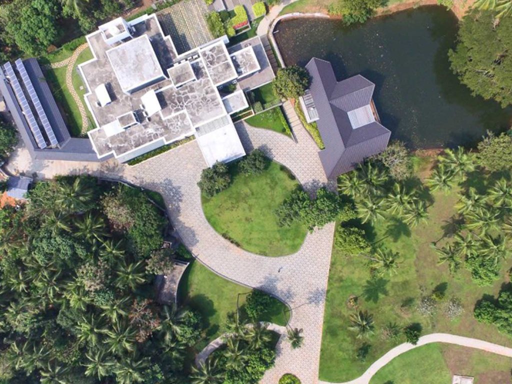 A bird 's eye view of a house with a pond.